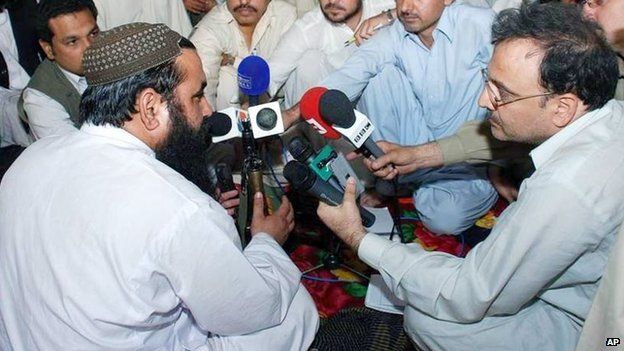 Baitullah Mehsud, left, talks to the media in Kotkai, a village in the Pakistani tribal area along the Afghan border in this photo taken on May 24, 2008,