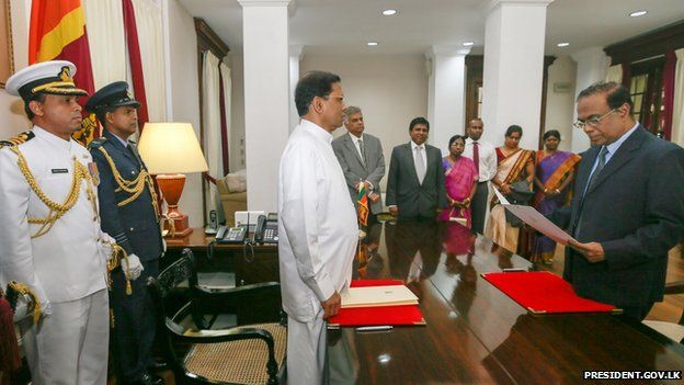 Judge Kanagasabapathy Sripavan (right) takes oath in front of President Maithripala Sirisena (centre)