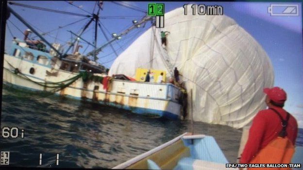 Handout image released by the Two Eagles Balloon Team showing the capsule envelope being recovered by a Mexican fishing boat