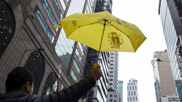 A pro-democracy protester holds up a yellow umbrella during Sunday's march (01 February 2015)