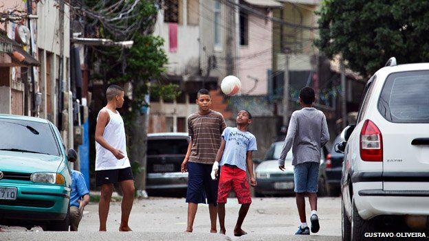 Children play football on a street in Vila Uniao in January 2015