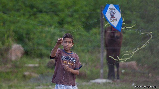 A child plays with a kite in Vila Uniao in January 2015