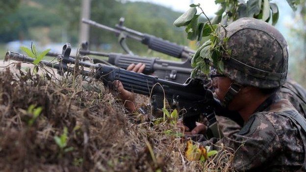 In this handout provided by the Hong Jin-Hwan-Donga Daily, South Korean soldiers patrol as they search for a soldier who is on the run after a shooting on 22 June 2014 in Goseong-gun, South Korea.