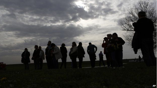 People pay their respects to the victims of the Vukovar massacre, at a memorial at Ovcara farm (Nov 2014)