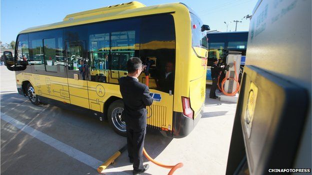 Electric bus being charged