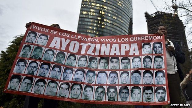 Relatives of the 43 missing students hold a poster during a protest march in Mexico City on 6 January, 2015.