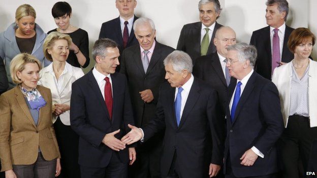 NATO Secretary General Jens Stoltenberg (front 2-L) shakes hand with US Secretary of Defense Chuck Hagel (front C) at a Nato meeting