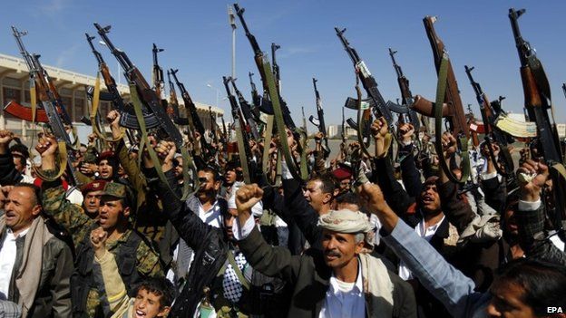 Tribal gunmen loyal to the Shiite Houthi Group shout slogans and hold weapons apparently to show support to the Group