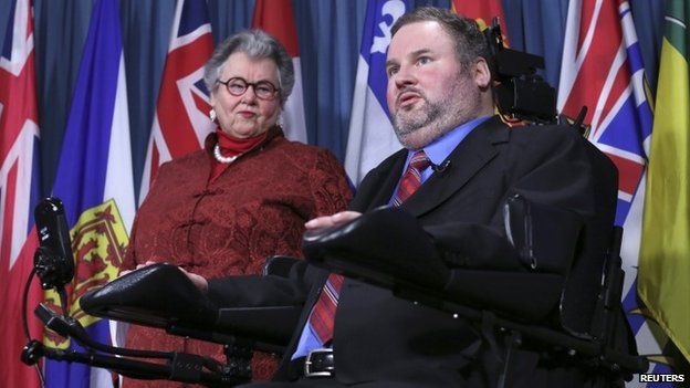 Conservative Member of Parliament Steven Fletcher (R) speaks during a news conference with Senator Nancy Ruth on Parliament Hill in Ottawa 2 December 2014