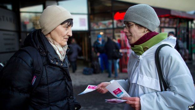 A volunteer distributes leaflets of the Alliance For Family to call for the participation at a referendum to maintain a ban on same-sex marriage in Bratislava on 2 February 2015