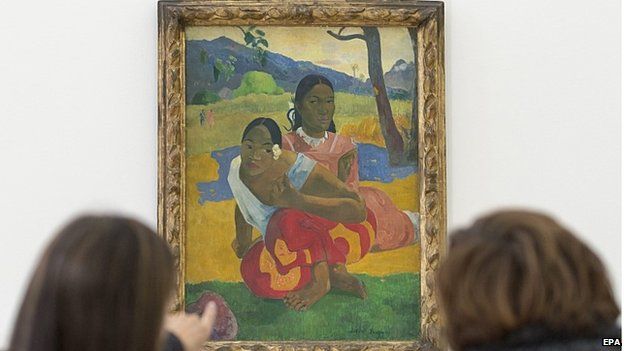 Two women look at the painting "Nafea faa ipoipo" (When will you marry?, 1892) by French painter Paul Gauguin on display in the Fondation Beyeler in Riehen, Switzerland, 06 February 2015