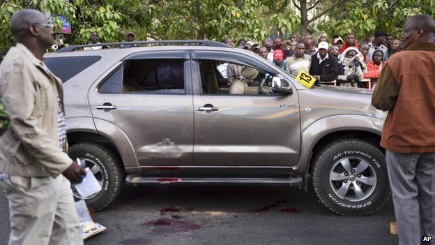 Onlookers gather at the scene after a Kenyan lawmaker was shot dead by gunmen on a main street in Nairobi, Kenya