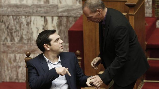 Alexis Tsipras (seated) and Yanis Varoufakis,