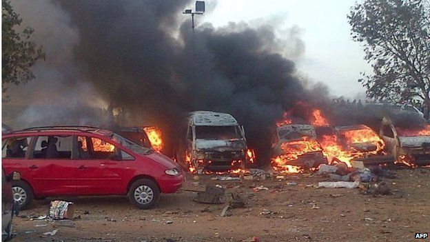 Vehicles burn after an attack in Abuja on 14 April 2014