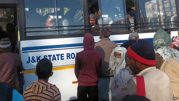 Passengers board an Indian Jammu and Kashmir state government bus departing to Pakistan-controlled Kashmir, at the Chakan-da-Bagh outpost near Poonch, some 250 kilometres from Jammu, the winter capital of Kashmir, on 28 January 2013