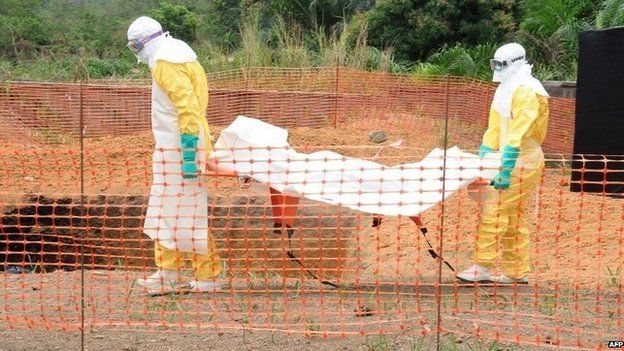 MSF staff carry the body of an Ebola victim in Guekedou, Guinea, on 1 April 2014