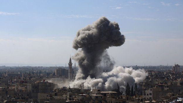 A cloud of smoke rises following an air strike in Douma