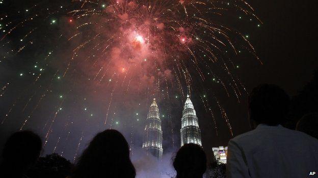 People watch fireworks over Malaysia's landmark Petronas Towers during New Year celebrations 01/01/2015