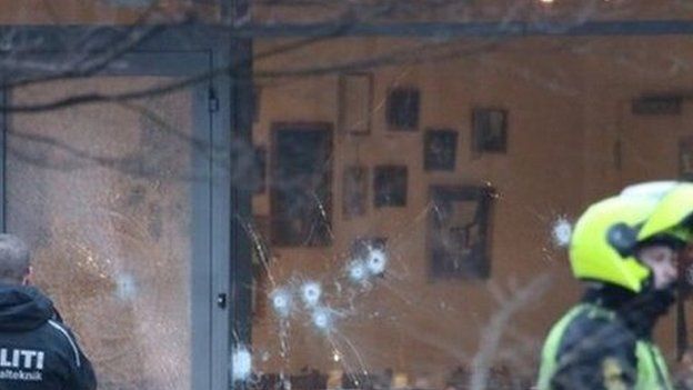 Bullet holes are seen in the window and door of Krudttonden cafe after shots were reportedly fired during a discussion meeting about art, blasphemy and free speech in Copenhagen, Denmark, 14 February 2015
