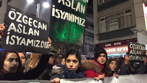 Women hold banners reading "Ozgecan Aslan is our rebellion" during protests against her murder in Istanbul on Saturday night