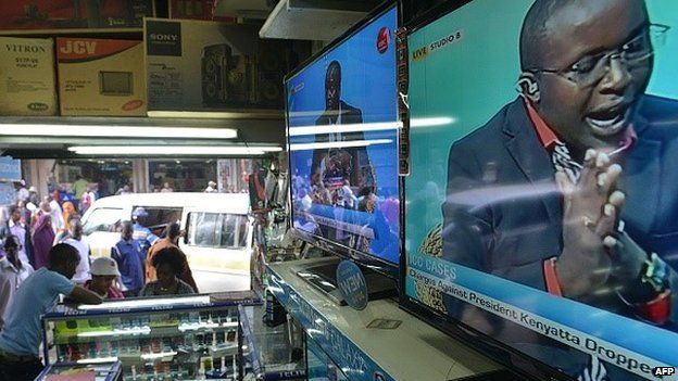 A televised debate on charges faced by Kenyan President Uhuru Kenyatta at the Hague-based International Criminal Court (ICC) being dropped, is aired on television sets displayed in an electronics shop, on 5 December 2014, in the Kenyan capital Nairobi