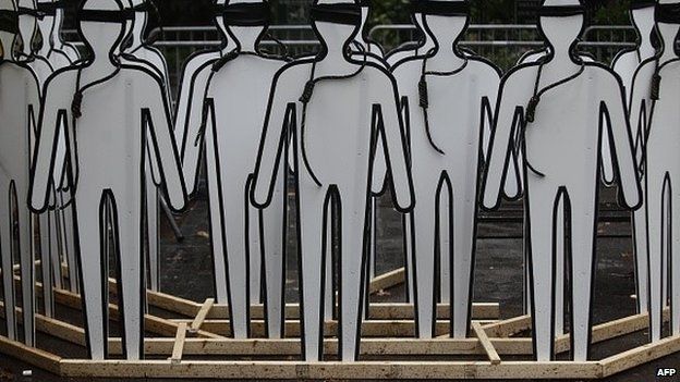 Cardboard cut outs made to resemble humans stand with nooses and blind folds as demonstrators protest Iranian President Hassan Rouhani outside the United Nations on September 25, 2014 during the 69th session of the United Nations General Assembly in New York