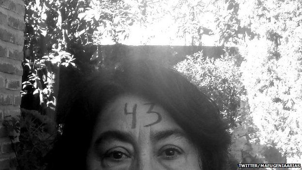 A woman with 43 painted on her forehead to show support for the 43 missing students in Mexico