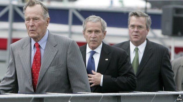 A file picture dated 07 October 2006 shows then US president George W. Bush (C) walking with his father the former President George H.W. Bush (L), and his brother then Florida Governor Jeb Bush following a christening ceremony the US Navy"s new aircraft carrier the George H.W. Bush, at the Northrop Grumman shipyard in Newport News, Virginia.