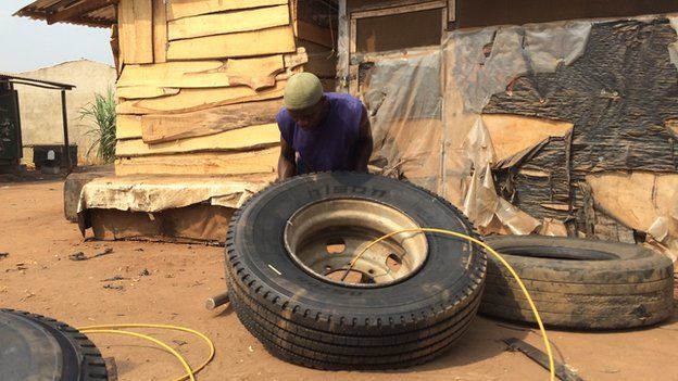 A tyre being pumped with air at Ogbere Trailer Park in Ogun state, Nigeria - February 2015