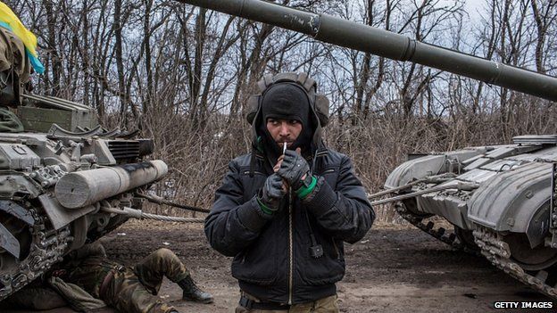 Ukrainian troops drive tanks out of Debaltseve. 19 Feb 2015
