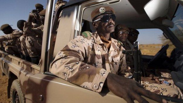 Malian soldiers sit in a vehicle on December 31, 2013 at the French military base in Gao, northern Mali.