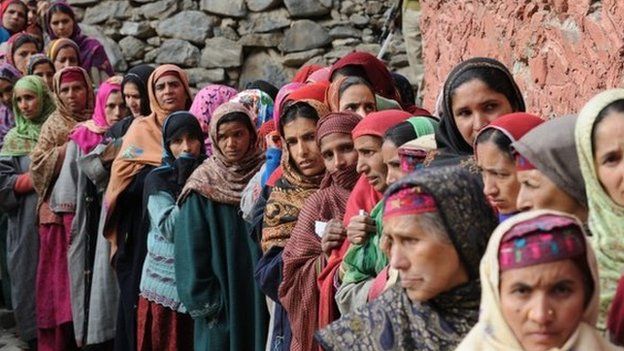 Kashmiri nomad voters queue outside a polling station in Babanagri on November 25, 201