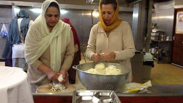 Two women prepare food