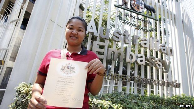 Thai surrogate mother Pattaramon Chanbua shows a certificate of Australian citizenship for the baby she gave birth to, to the media at the Australian Embassy, in Bangkok February 9, 2015