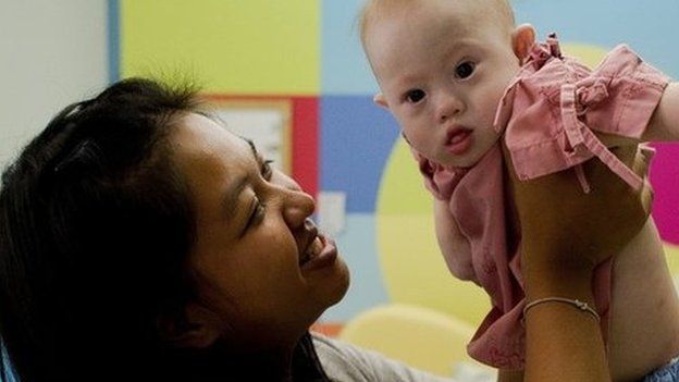 This file photo taken on August 4, 2014 shows Thai surrogate mother Pattaramon Chanbua (L) holding her baby Gammy, born with Down syndrome, at the Samitivej hospital, Sriracha district in Chonburi province