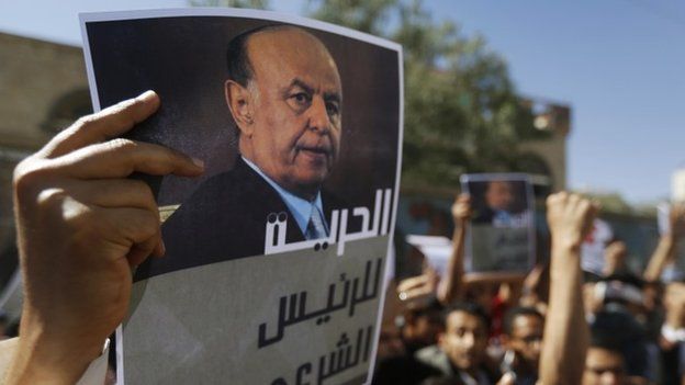 A protester holds up a poster of Yemen's former president Abd-Rabbu Mansour Hadi during an anti-Houthi demonstration in Sanaa