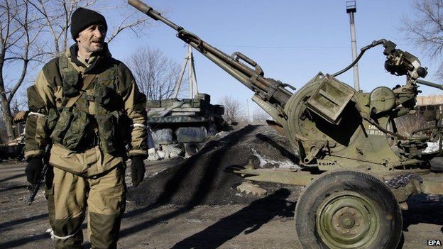 Rebel walks past anti-aircraft gun in Debaltseve - 21 February