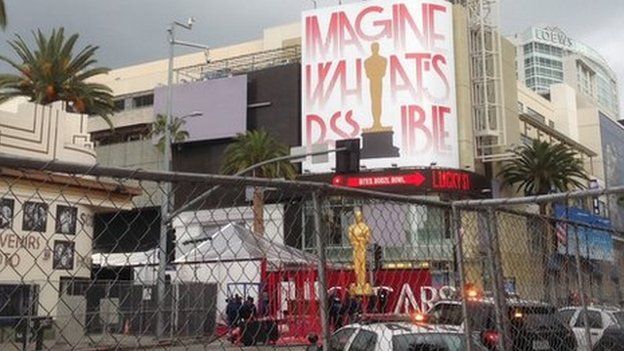 Final touches being made to the red carpet at the Oscars 2015