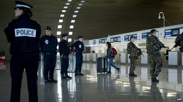 French soldiers and police patrol at the Charles de Gaulle airport in Paris - 17 January 2015