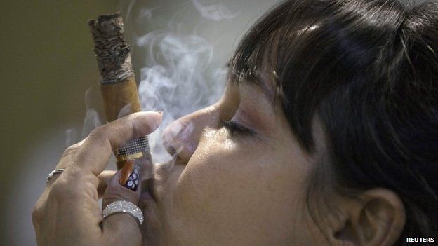 Cigar sommelier Ivonne de La Puente, 47, smokes a cigar during the XVII Habanos Festival in Havana, February 23, 2015