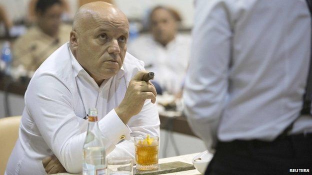 A member of the jury, (L), listens to a sommelier during a cigar sommelier contest at the XVII Habanos Festival in Havana, February 23, 2015