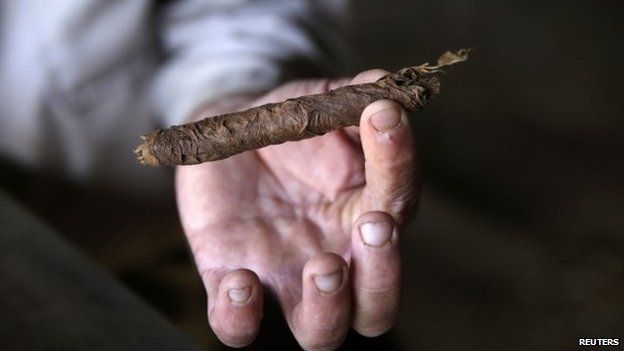 A farmer shows a cigar after rolling it at a plantation in the valley of Vinales, in the western Cuban province of Pinar del Rio January 26, 2015