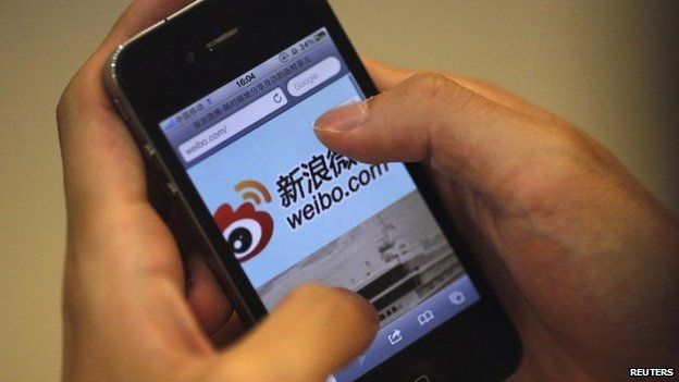 File image of a man using the Sina Weibo microblogging site in Shanghai on 29 May 2012