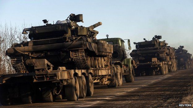 Military trucks from the Ukrainian armed forces transport tanks on the road near Artemivsk, eastern Ukraine, 24 February 2015