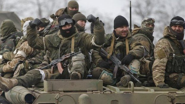 A Russia-backed rebel gestures while ridding on an armored vehicle in Debaltseve, Ukraine, 20 February 2015