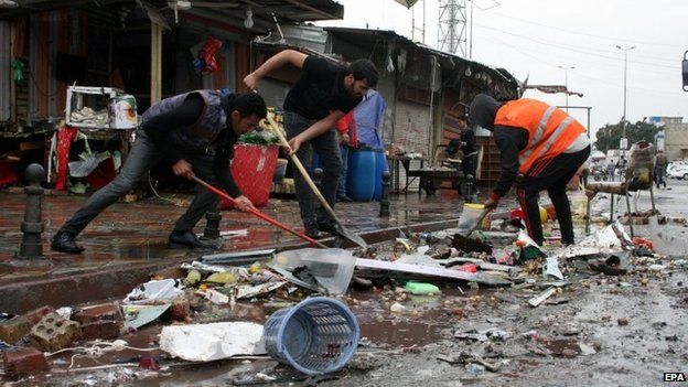 Iraqis remove debris after a bomb attack at new Baghdad district in eastern Baghdad, Iraq, 07 February 2015