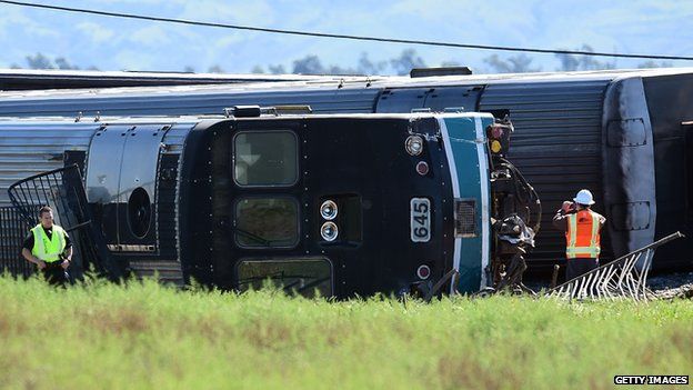 Investigators inspecting overturned carriages