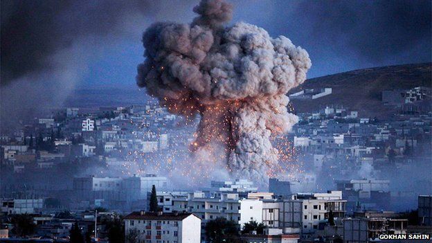 An explosion rocks Syrian city of Kobani during a reported suicide car bomb attack by the militants of Islamic State (ISIS) group on a People's Protection Unit (YPG) position in the city center of Kobani, as seen from the outskirts of Suruc, on the Turkey-Syria border, October 20, 2014 in Sanliurfa province, Turkey