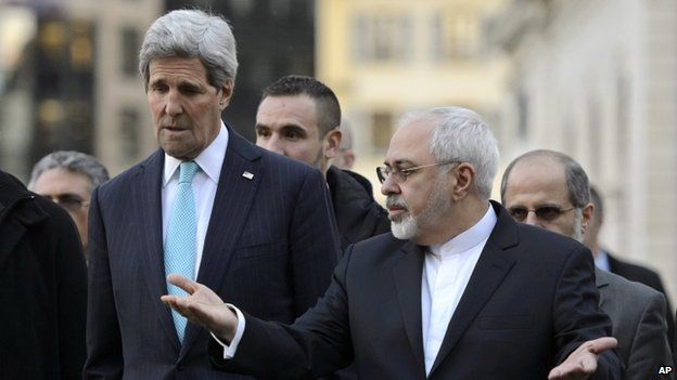 US Secretary of State John Kerry, left, listens to Iranian Foreign Minister Mohammad Javad Zarif, as they walk in the city of Geneva, Switzerland 14 January 2015