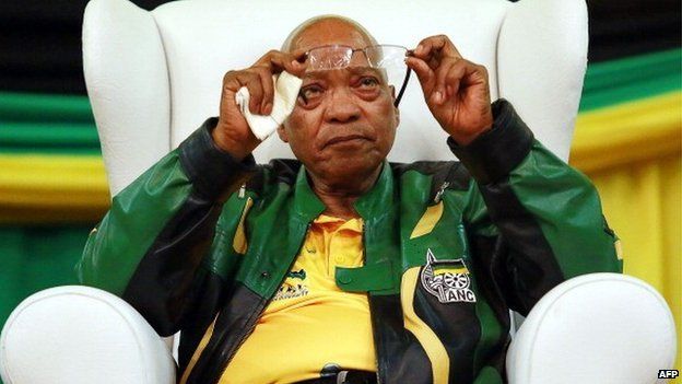 South African President and African National Congress (ANC) President Jacob Zuma cleans his glasses during a campaign event at the Inter-fellowship Church in Wentworth township, outside of Durban, on 9 April 2014